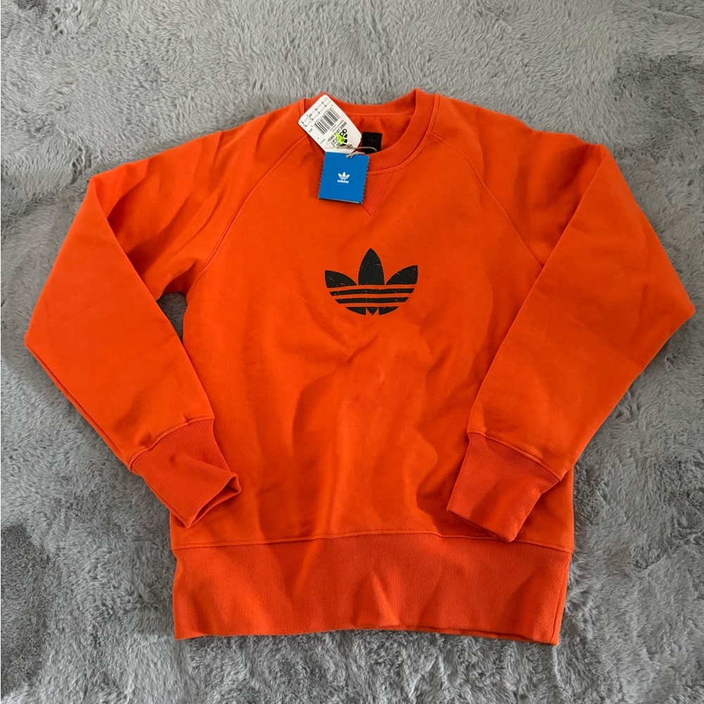 Bright orange Adidas sweat shirt.